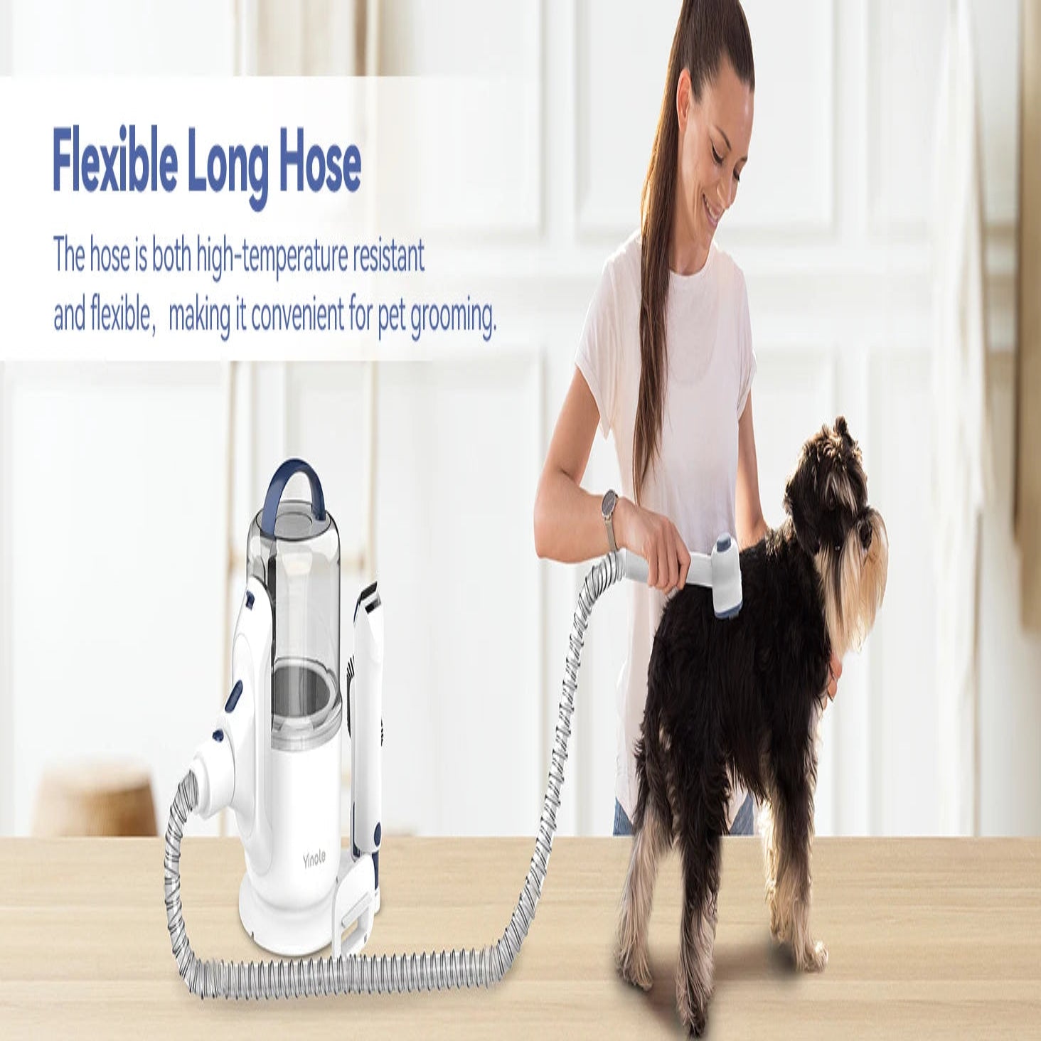 Person grooming a dog with a flexible long hose device in a home setting.