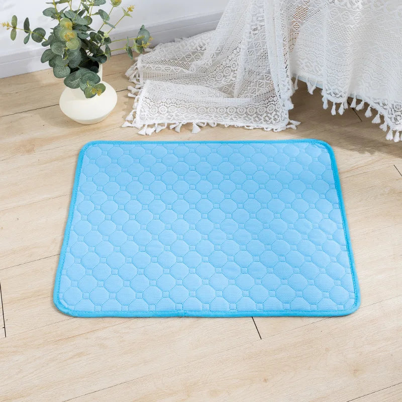 Blue quilted washable dog pee pad on a wood floor | Pawnests