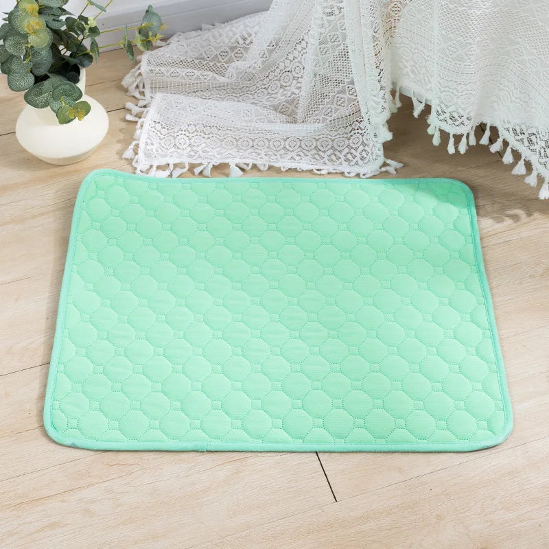 Green quilted washable dog pee pad on a wood floor | Pawnests