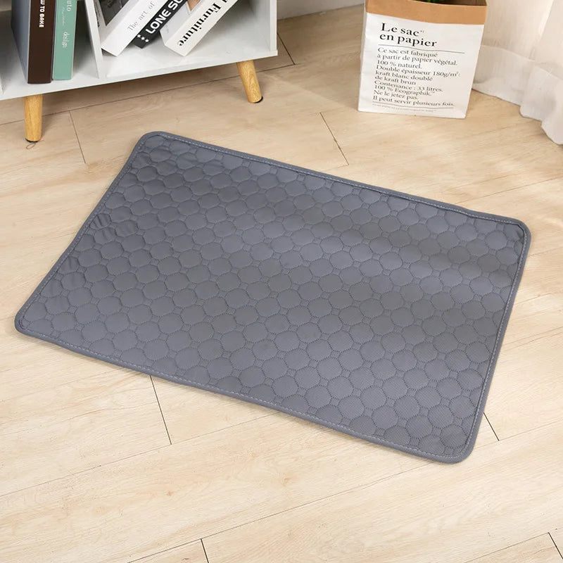 Grey quilted washable dog pee pad on a wood floor | Pawnests